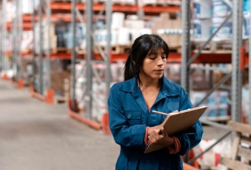 woman-worker-taking-notes-warehouse_23-2149128300